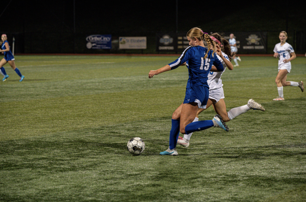 Katie Bucher (11) makes a pass up the field. Bucher said, "I thought we moved the ball pretty well. Lex Cath is a good team so being able to get around them and have scoring opportunities was good for us."